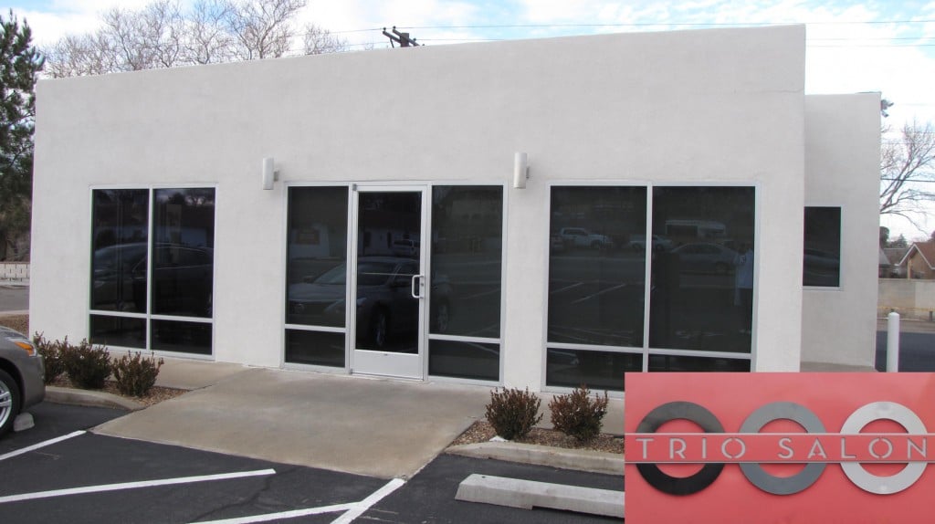 Trio Salon storefront with darkly tinted windows along the full facade