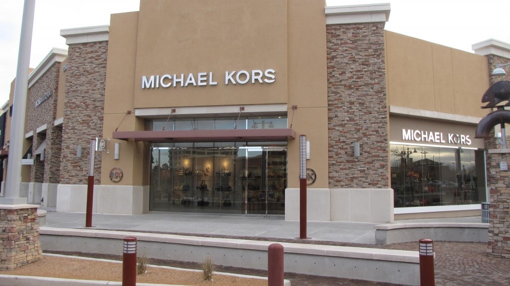 Michael Kors retail storefront with tinted glass entry doors and display windows